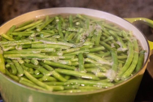 Green beans cooking in a pot of water