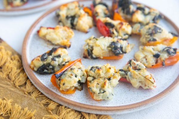 Horizontal photo of stuffed peppers on a plate, ready to be served.