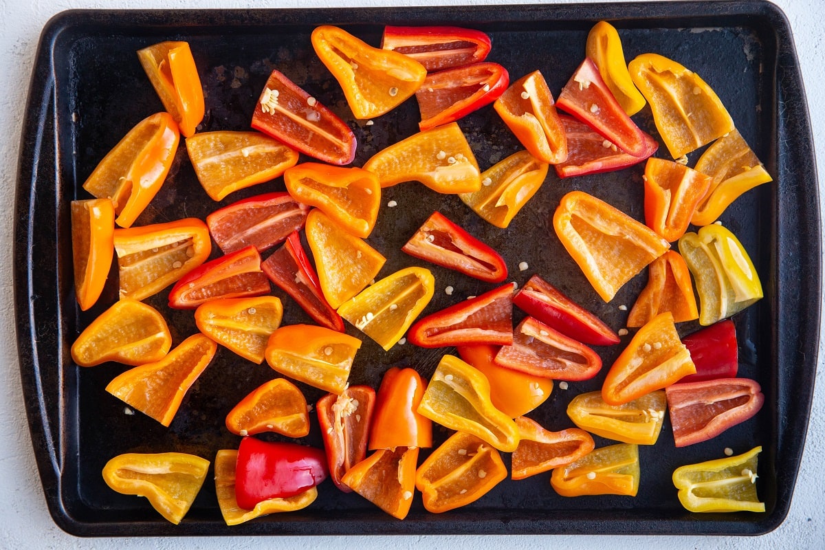 Mini sweet peppers on a baking sheet ready to be roasted