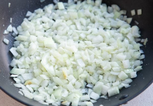 Onions cooking in a nonstick skillet