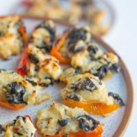 Close up of feta stuffed peppers on a plate.