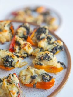 Close up of feta stuffed peppers on a plate.