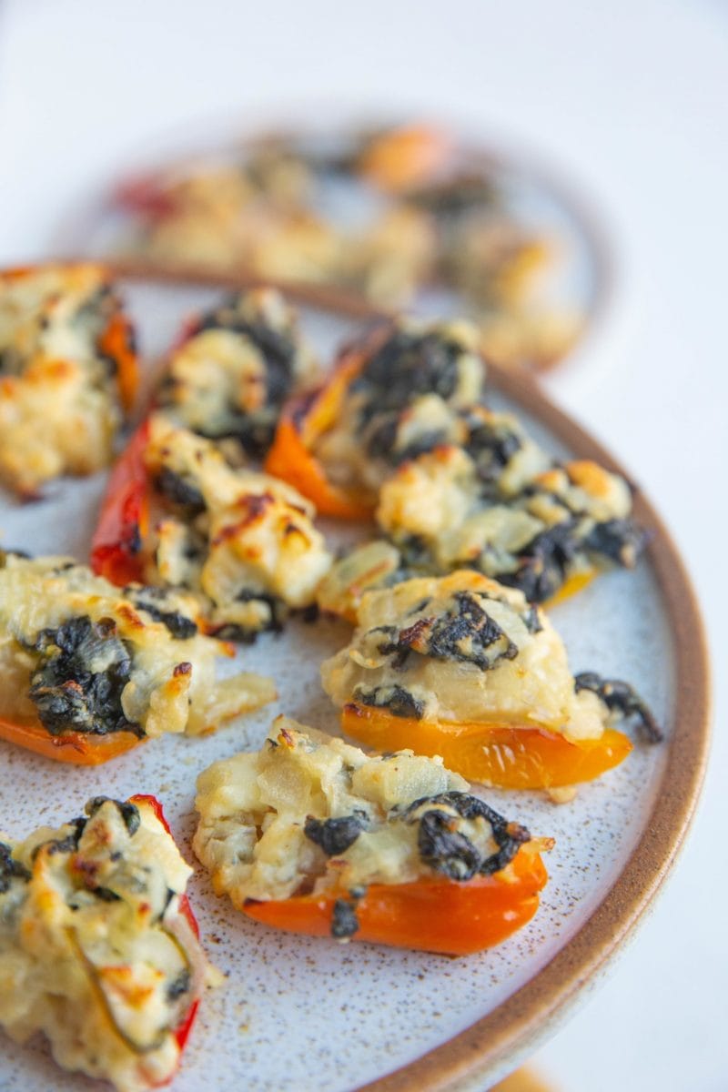 Close up of feta stuffed peppers on a plate.