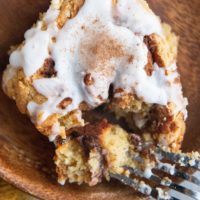 Close up top down photo of a cinnamon roll with a bite taken out.