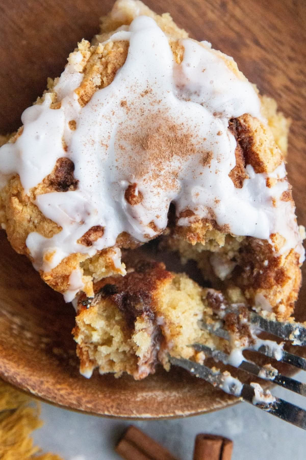 Close up top down photo of a cinnamon roll with a bite taken out.