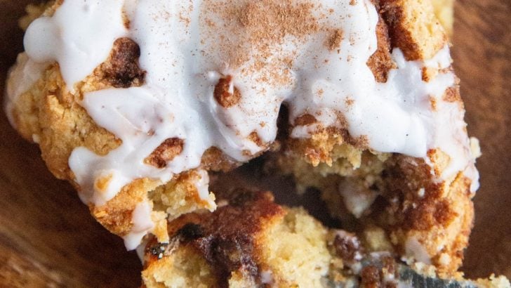 Close up top down photo of a cinnamon roll with a bite taken out.