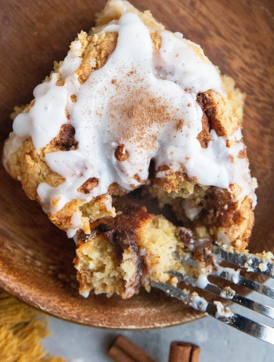 Close up top down photo of a cinnamon roll with a bite taken out.
