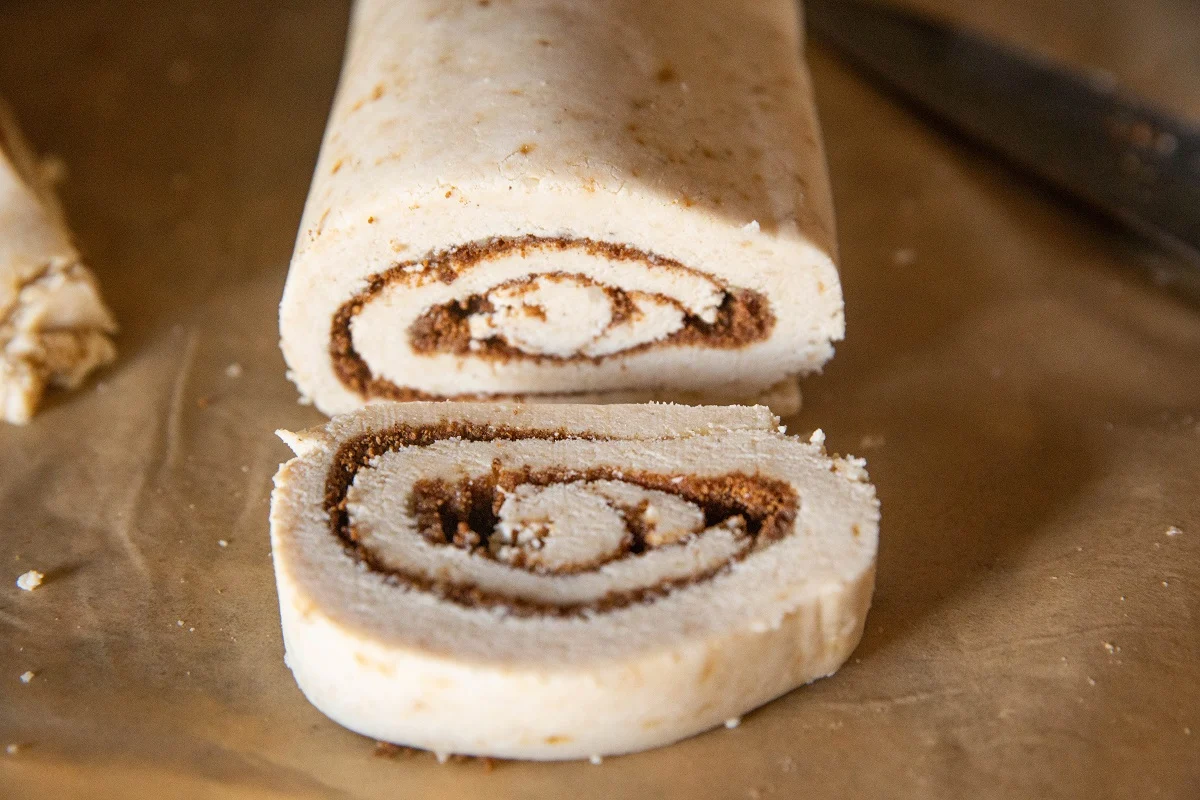Cinnamon roll log with a slice taken out to make rolls