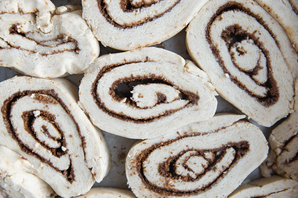 Raw cinnamon rolls in a baking dish, ready to go into the oven.