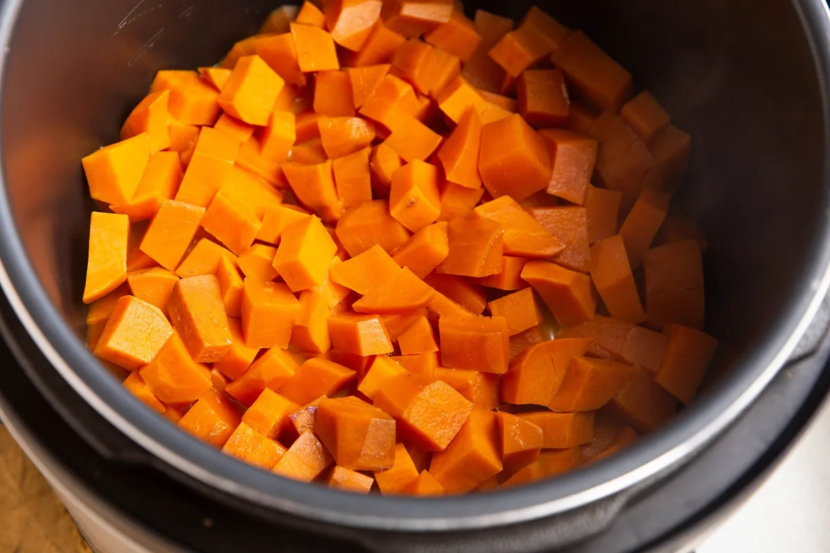 Cooked chopped sweet potatoes in an Instant Pot, ready to be mashed.
