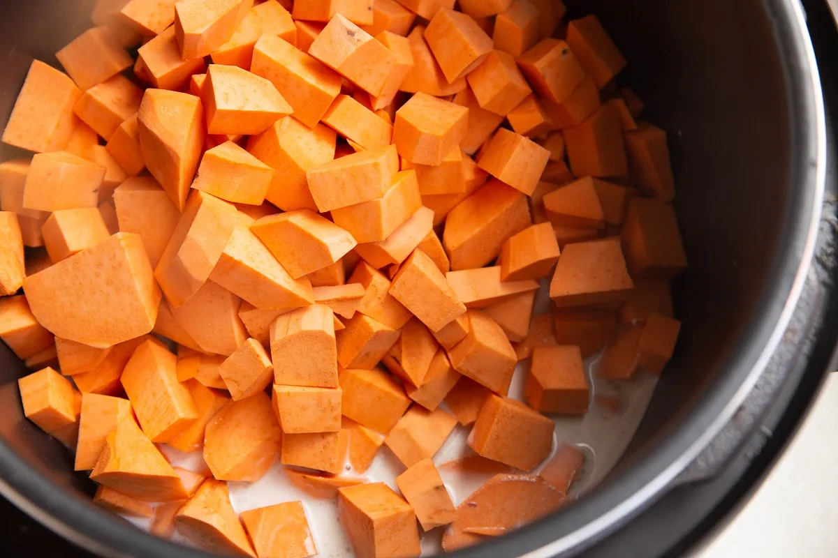 Ingredients for mashed sweet potatoes in an Instant pot, ready to be cooked