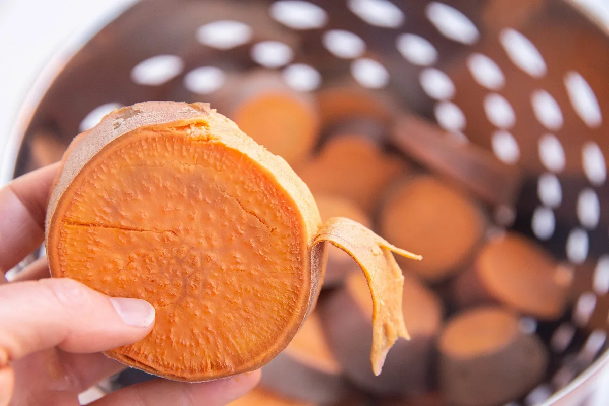 Peeling the outer skin off the the sweet potato