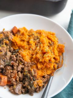 Bowl of mashed sweet potatoes and ground meat with vegetables