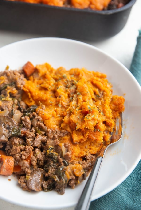 Bowl of mashed sweet potatoes and ground meat with vegetables