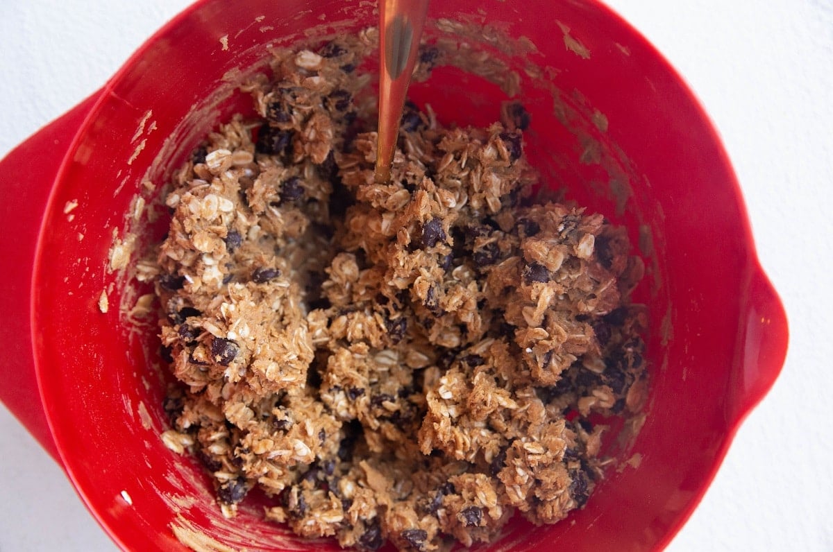 peanut butter oatmeal cookie dough in a mixing bowl, ready to bake.