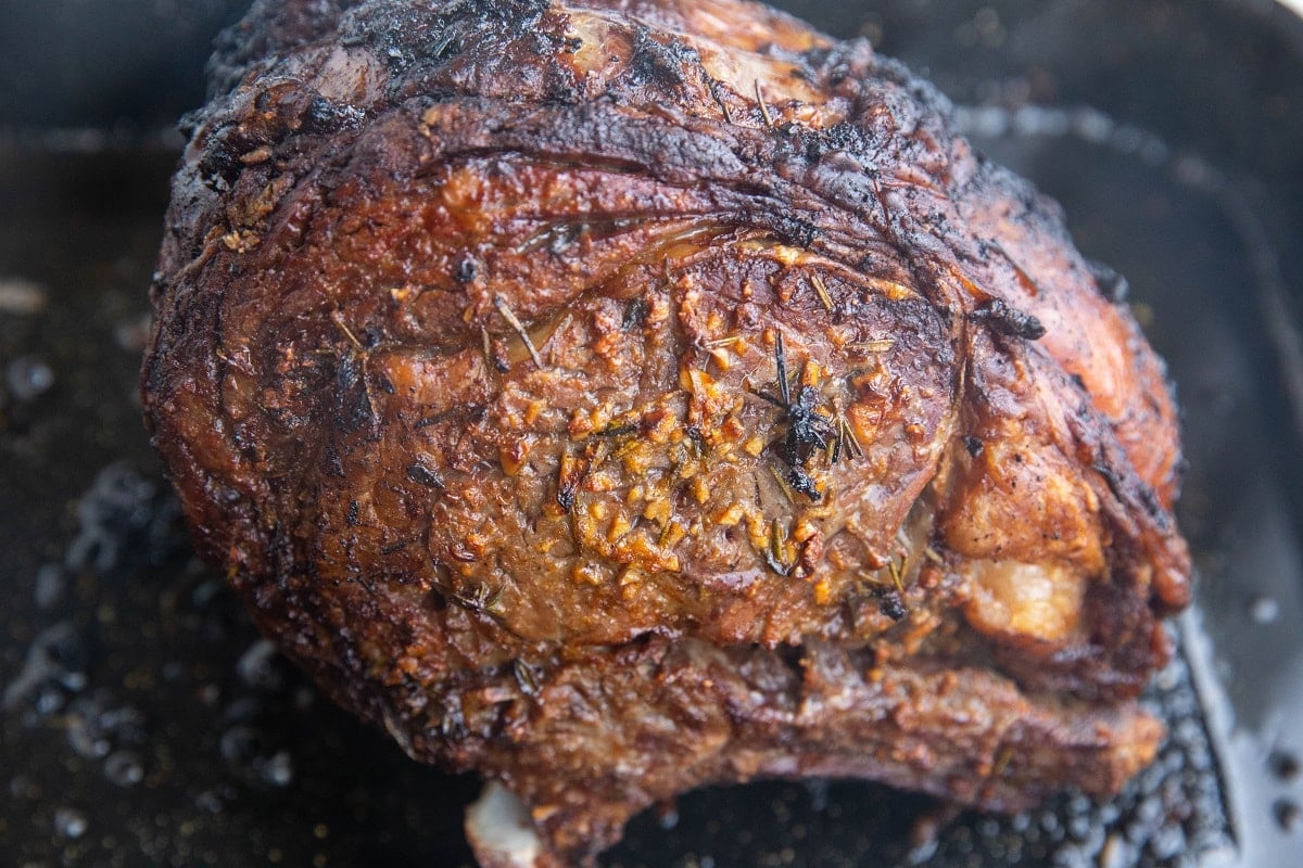 Garlic Herb Crusted Prime Rib fresh out of the oven in a roasting pan.