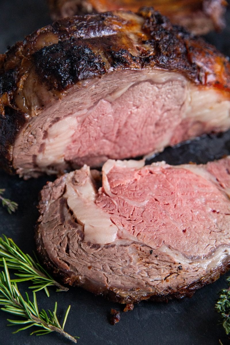 Garlic Butter Prime Rib on a cutting board, sliced.