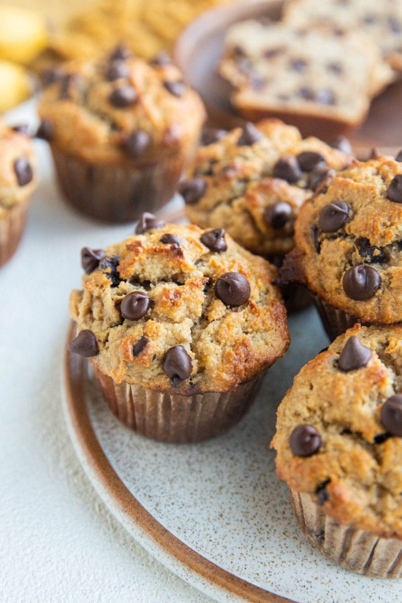 Close up angled shot of a plate of chocolate chip banana muffins