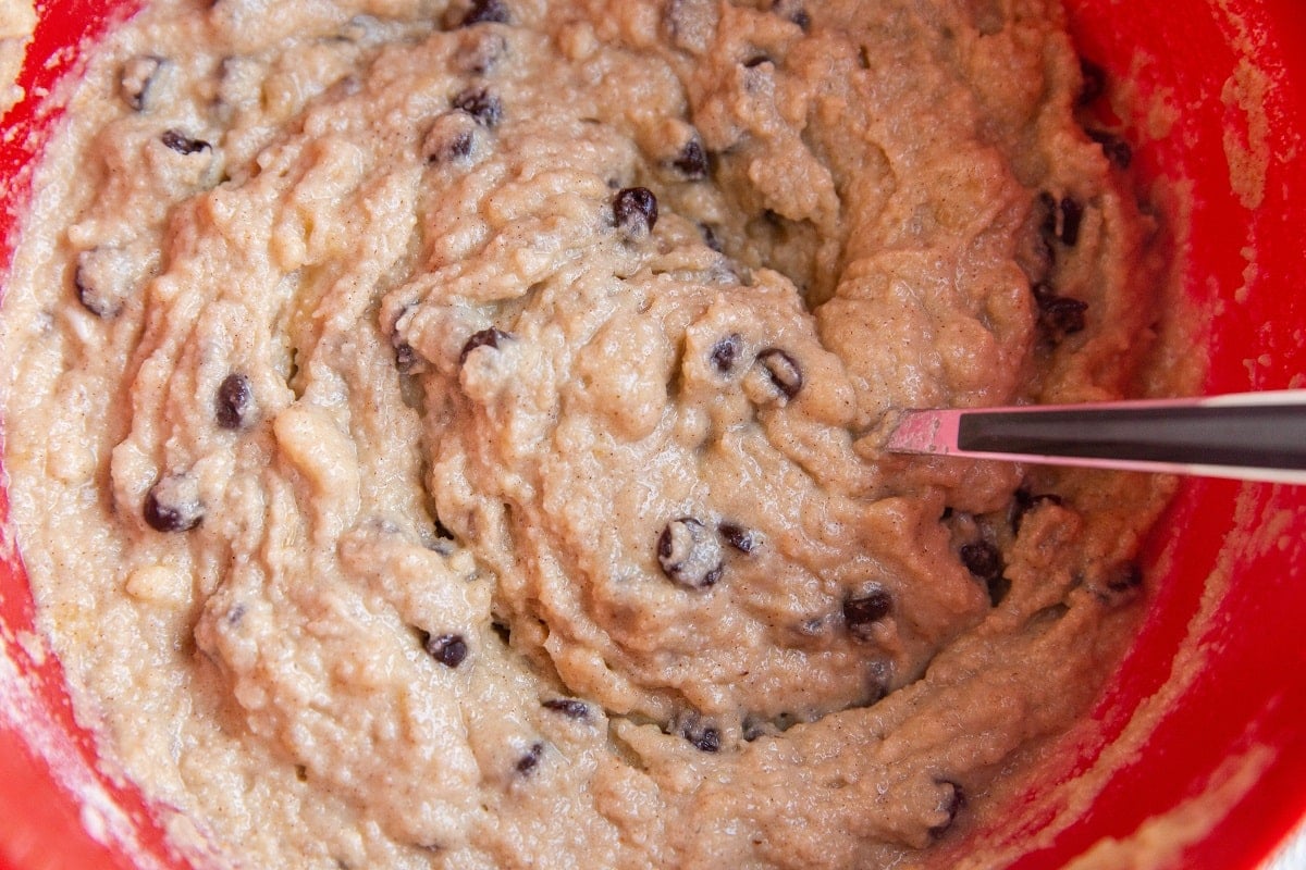 Chocolate chip banana muffin batter all mixed up in a mixing bowl.