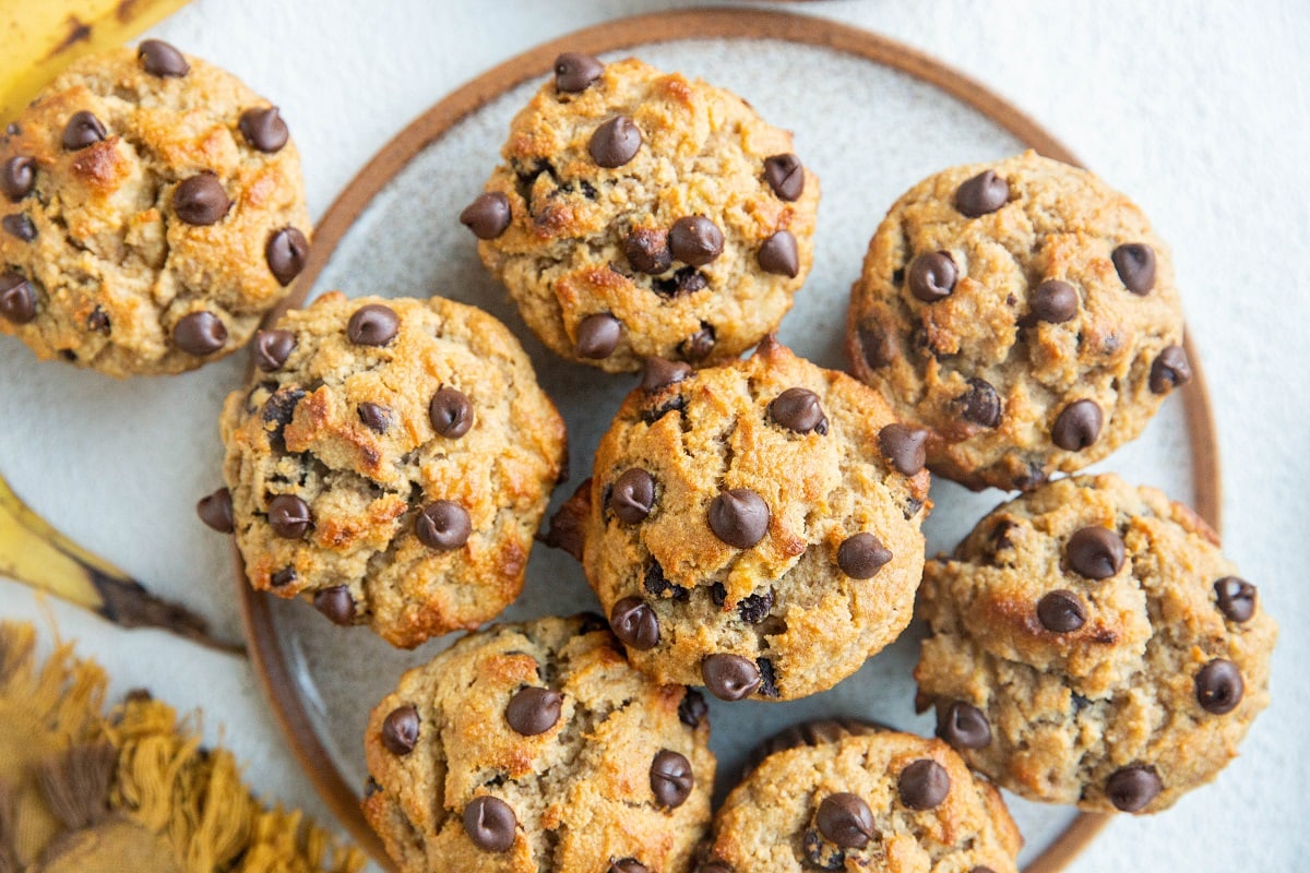 Horizonal image of a plate of banana chocolate chip muffins.