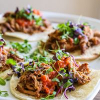 Barbacoa beef tacos on a serving platter