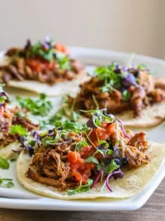 Barbacoa beef tacos on a serving platter