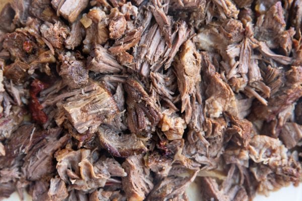 Shredded beef on a cutting board.