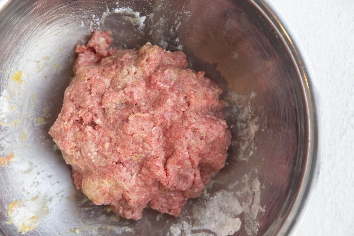 Meatball mixture in a mixing bowl.