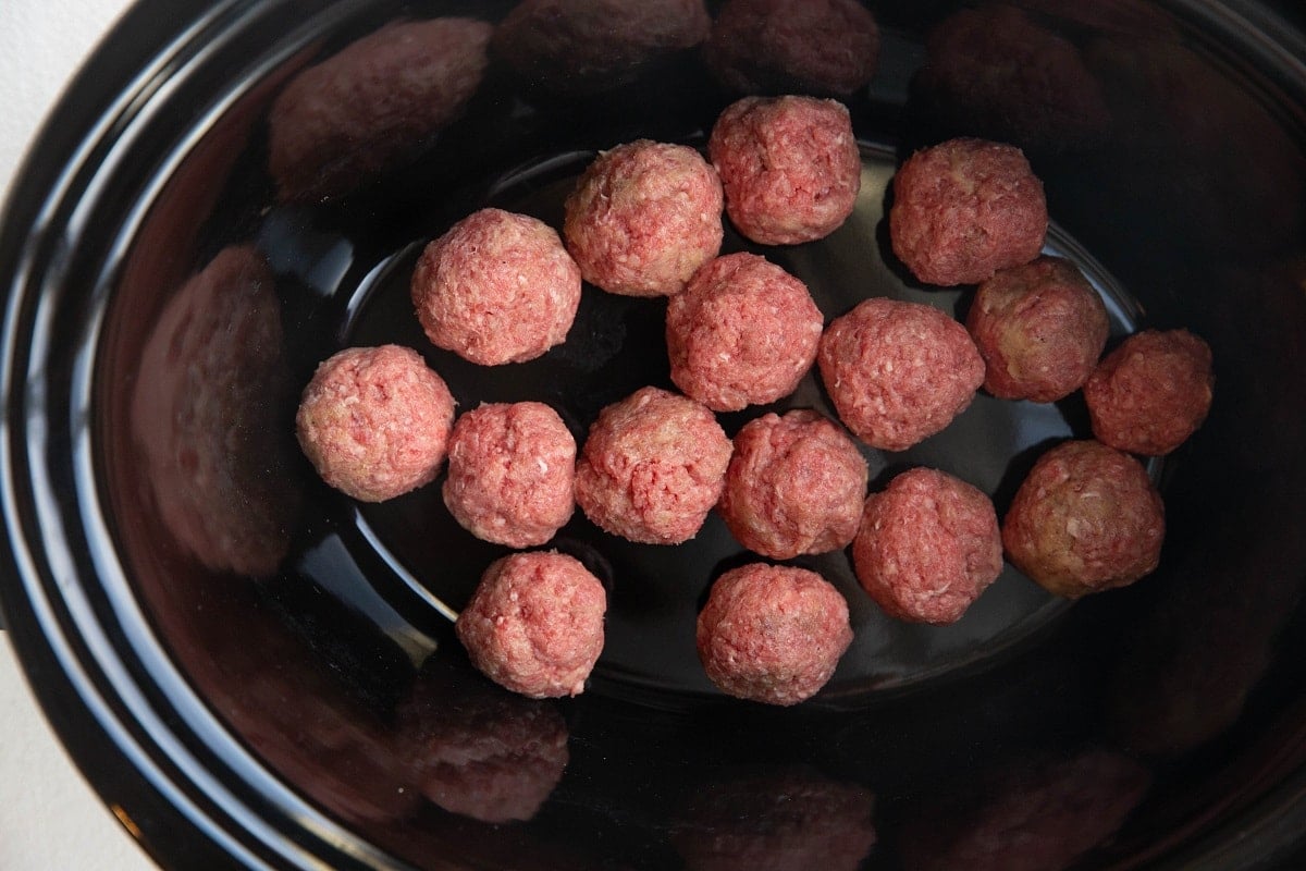 Meatballs at the bottom of a crock pot.