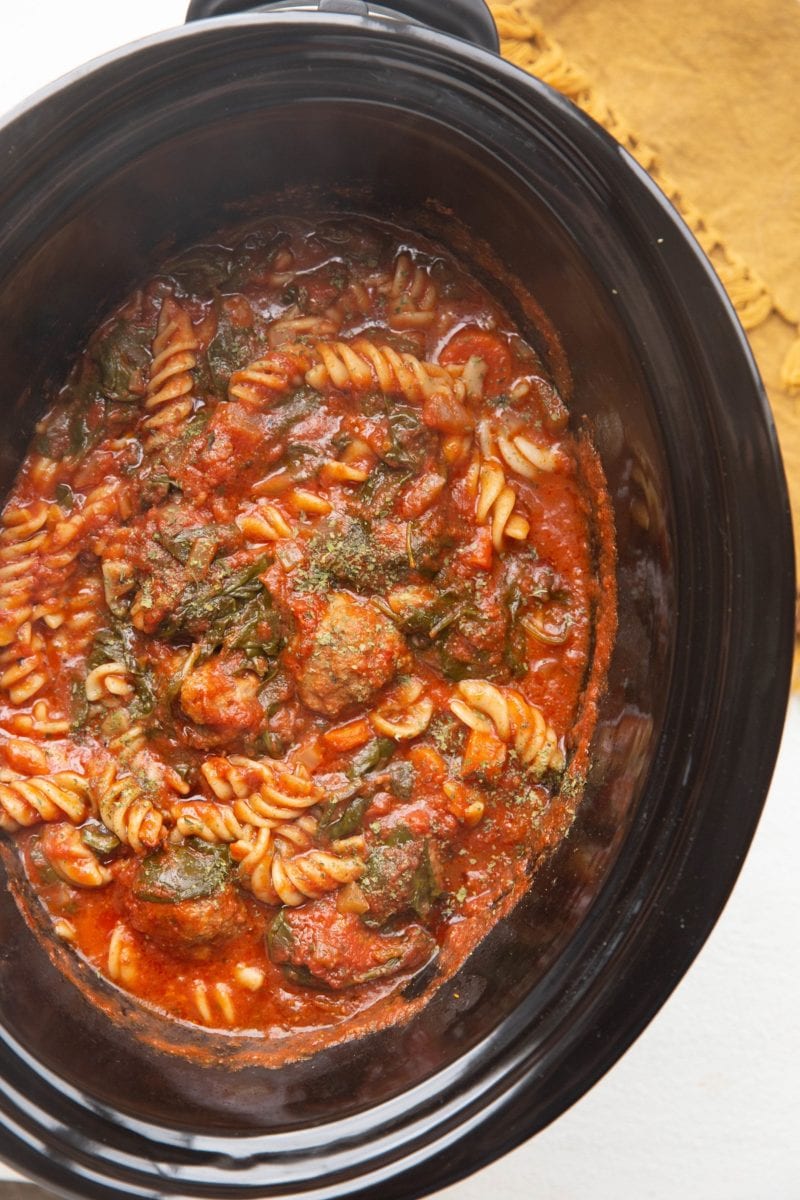 Vertical image of the whole crock pot full of meatball soup.