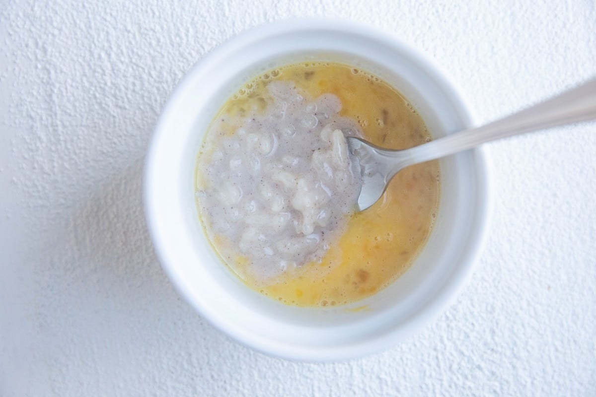 Rice pudding mixed with egg in a bowl.