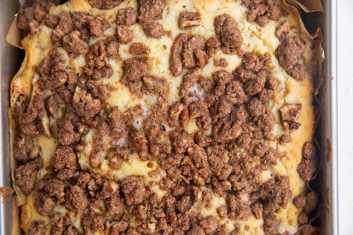 Delicious gluten-free coffee cake in a cake pan, fresh out of the oven.