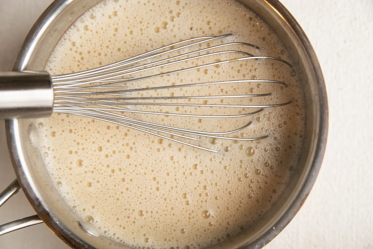 Custard mixture in a saucepan for bread pudding