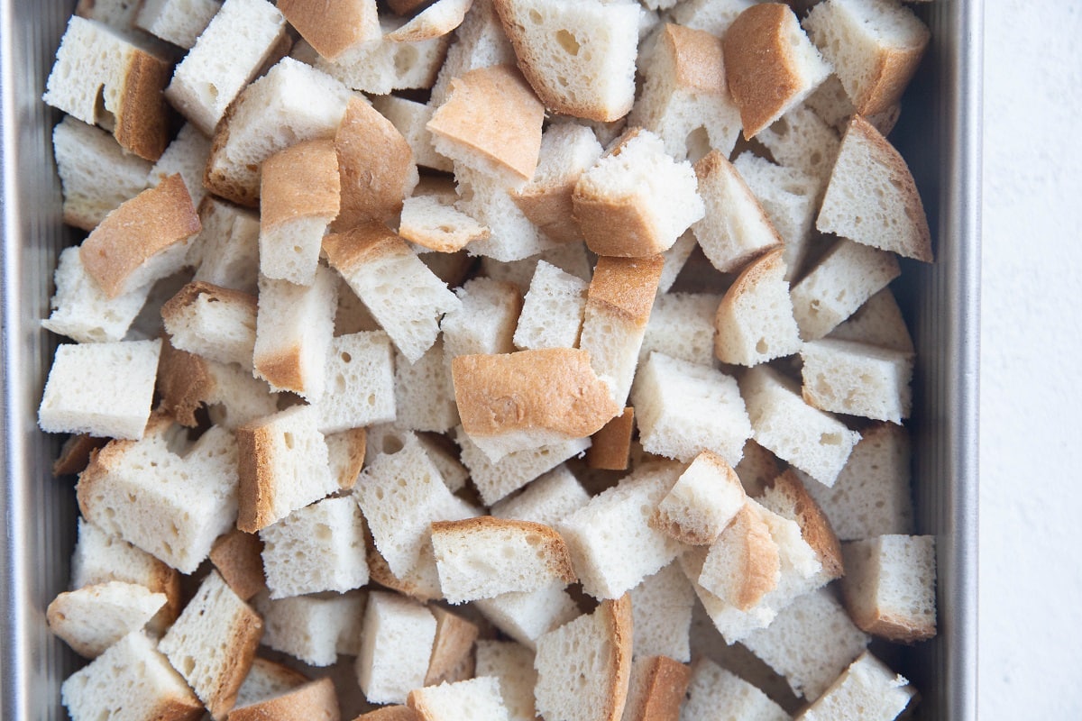 Chopped bread in a baking dish.