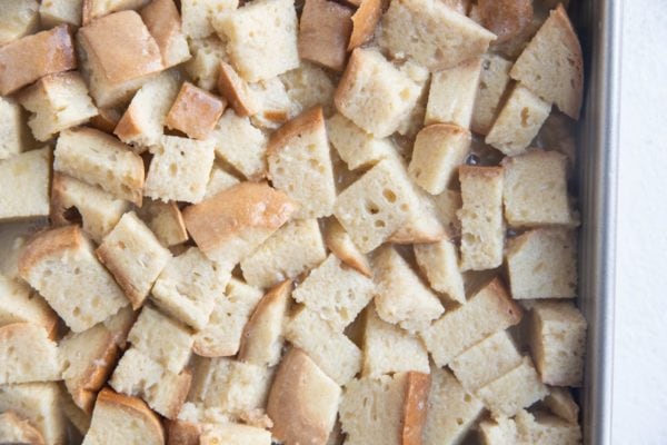 Baking dish with chopped bread saturated with custard.