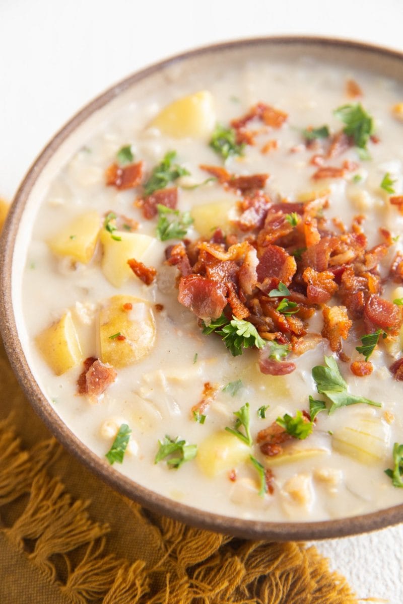 Close up angled shot of a bowl of clam chowder.