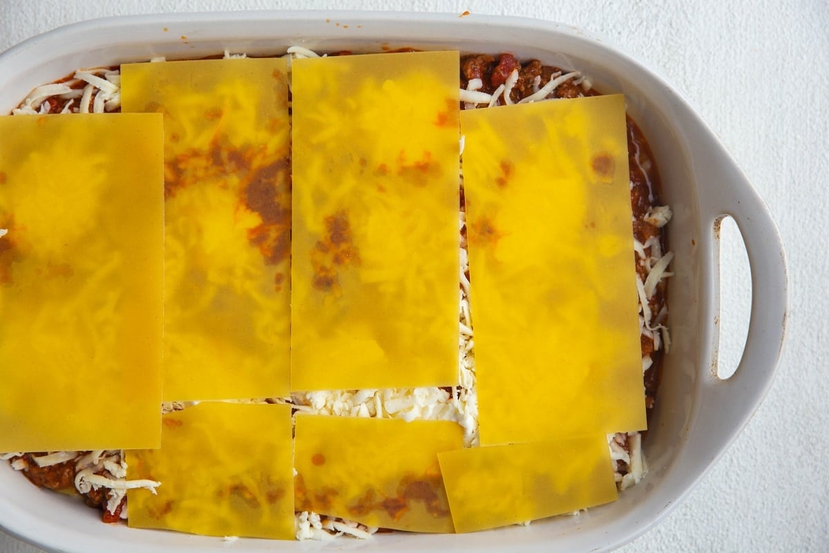 Layer of noodles on top of the first layer of lasagna, beginning the second layer of lasagna.