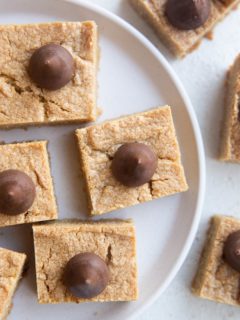 White plate of peanut butter blossom cookie bars.