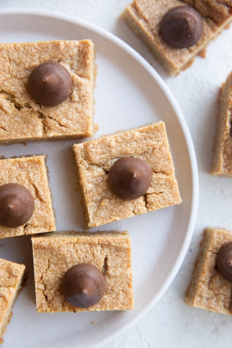 White plate of peanut butter blossom cookie bars.