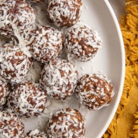 Top down plate of coconut chocolate snowballs.