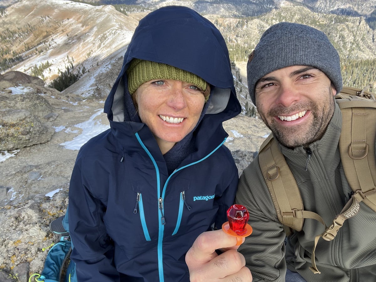 Jeff and Julia on top of a mountain with a ring pop
