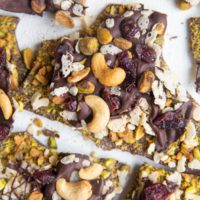 Top down photo of chocolate bark broken into chunks on a white backdrop.