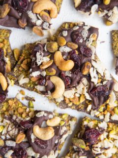 Top down photo of chocolate bark broken into chunks on a white backdrop.