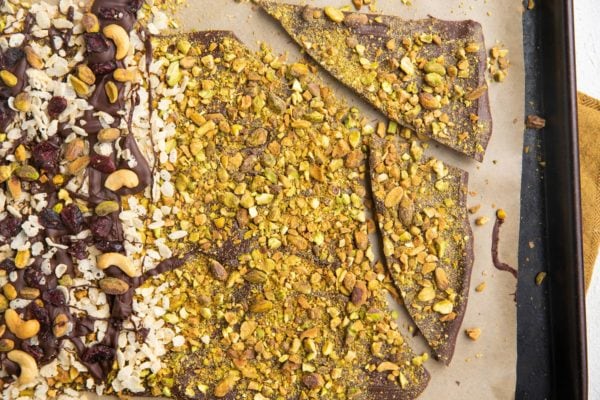 Chocolate bark broken up on a baking sheet into smaller chunks.