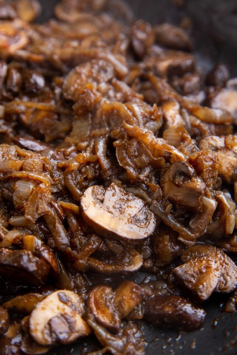 Vertical image of finished sauteed onions and mushrooms.