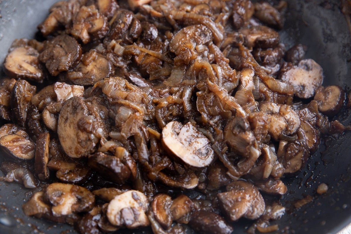 Finished caramelized onions and mushrooms in a skillet.