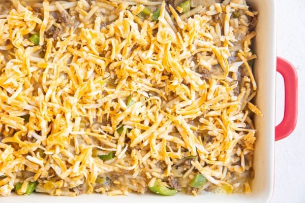 Grated cheese sprinkled over the casserole ingredients, ready to go into the oven.