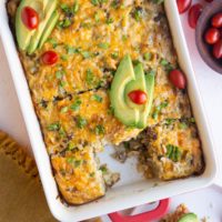 Taco breakfast casserole with sliced avocado on top.