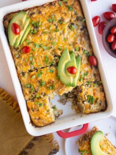 Taco breakfast casserole with sliced avocado on top.