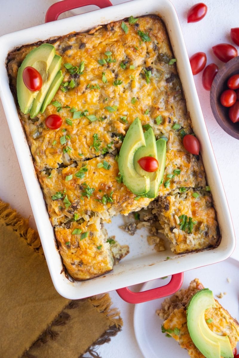 Taco breakfast casserole with sliced avocado on top.